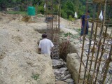 Workers setting foundation pillars